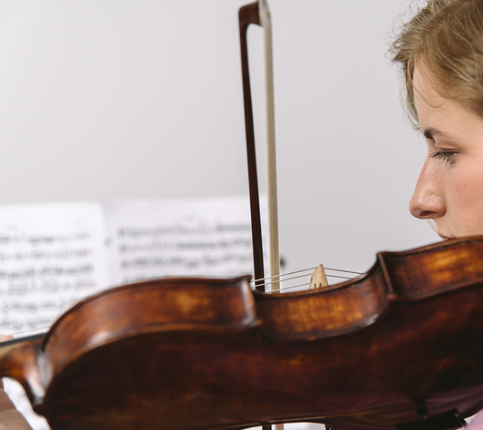 A woman practicing the violin-Fiddlover blog